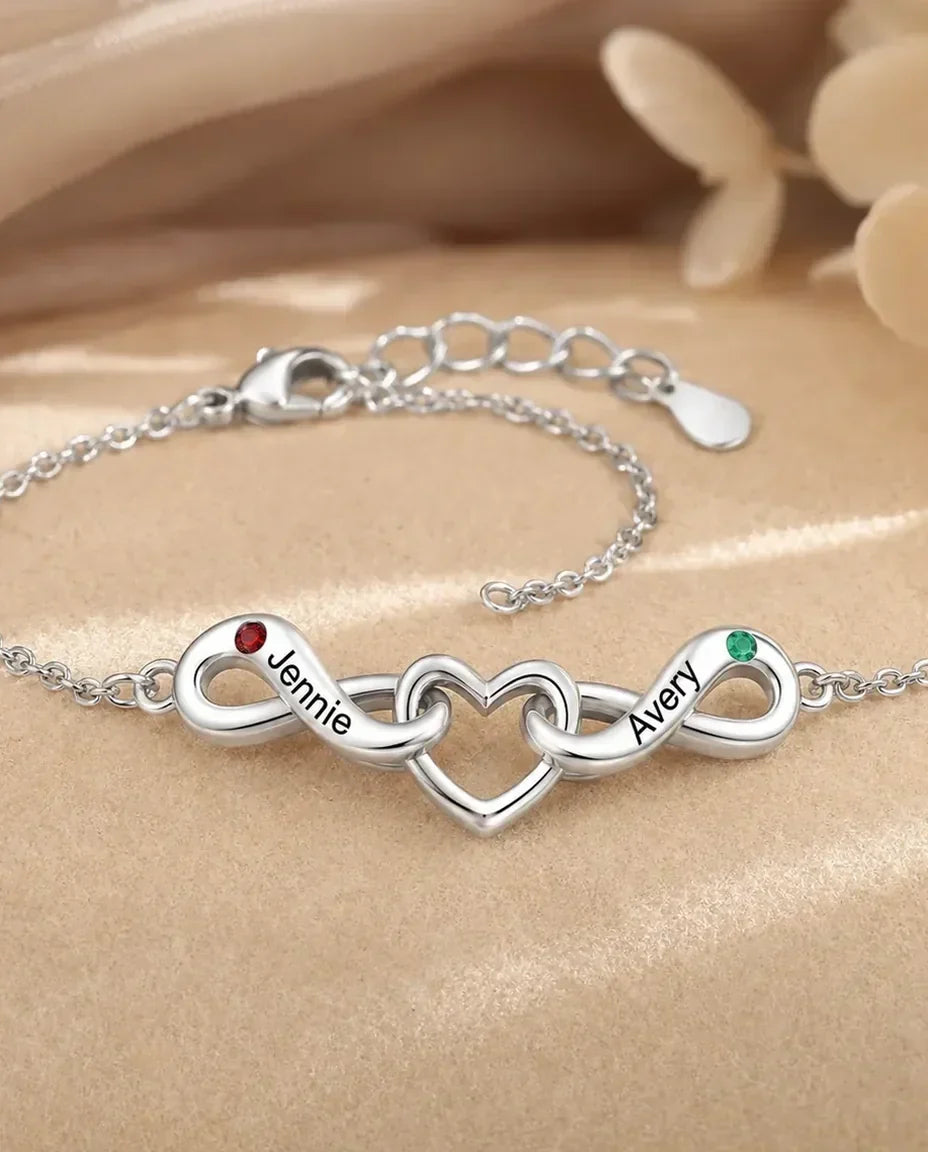Bracciale Infinito Personalizzato 2 Nomi - due nodi infiniti attorno a un cuore e due pietre portafortuna