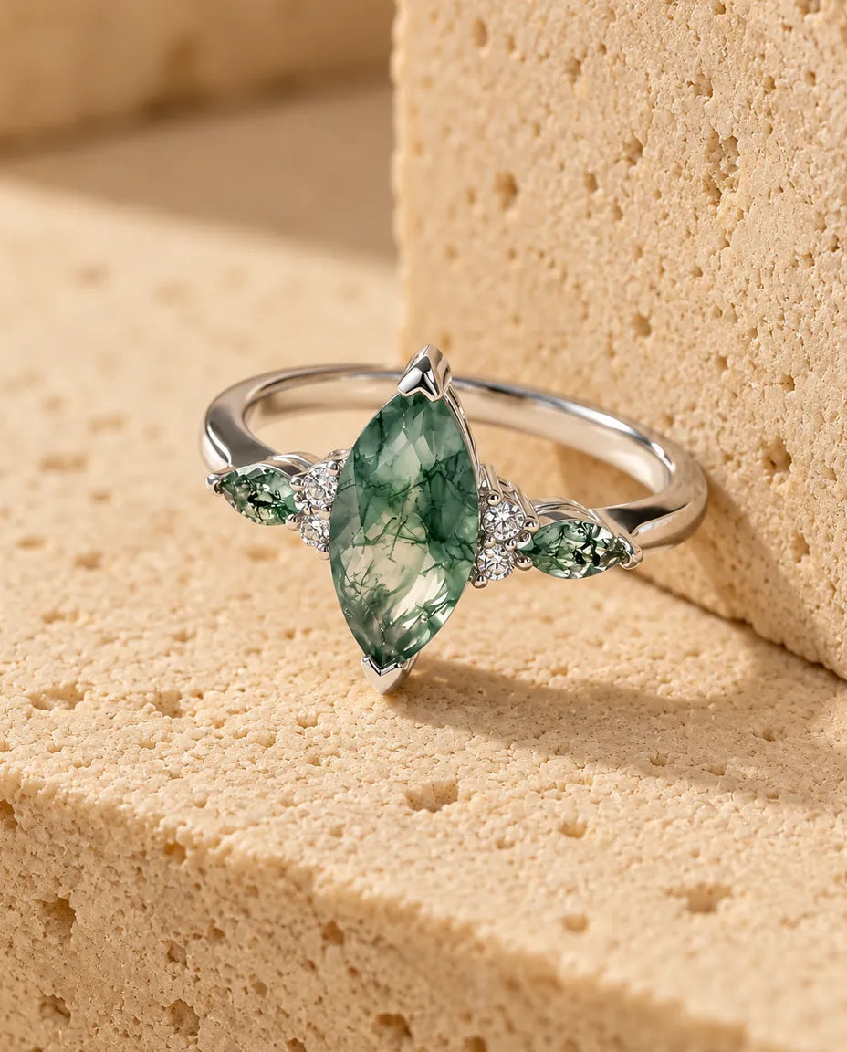 Anello Agata Muschiata Taglio Marquise - esposto su un blocco di travertino