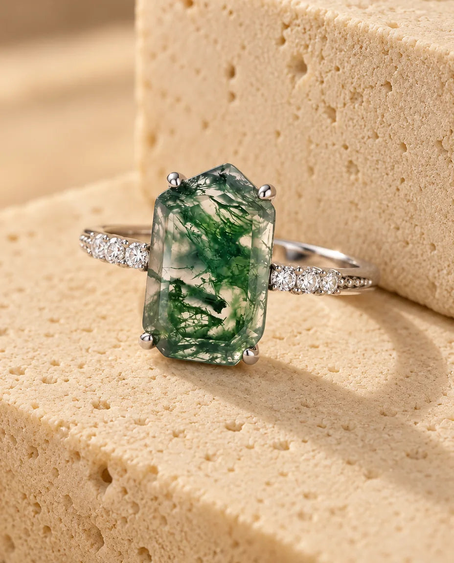 Anello Agata Muschiata Taglio Smeraldo 7x11 mm - esposto su un blocco di travertino