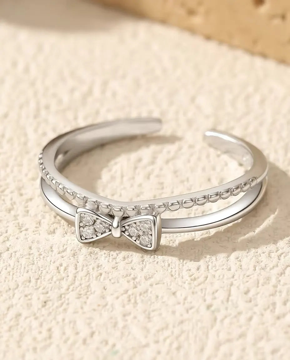 Anello fiocco con zirconi - fiocco a pavé da 3,5 x 7 mm su fascia doppia con filo perlato, regolabile, argento 925, US 6-9