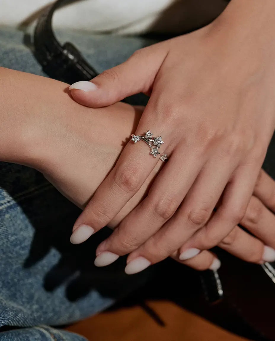 Anello Moissanite Stelle in Argento 925 - indossato alla mano da una modella appoggiata sul jeans