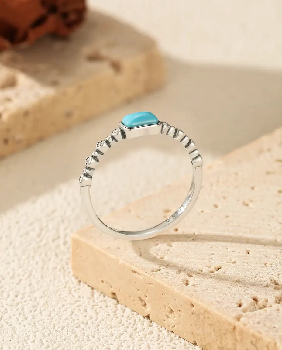 Anello Turchese - cabochon rettangolare su fascia perlata di zirconi, misure 5-9, argento 925