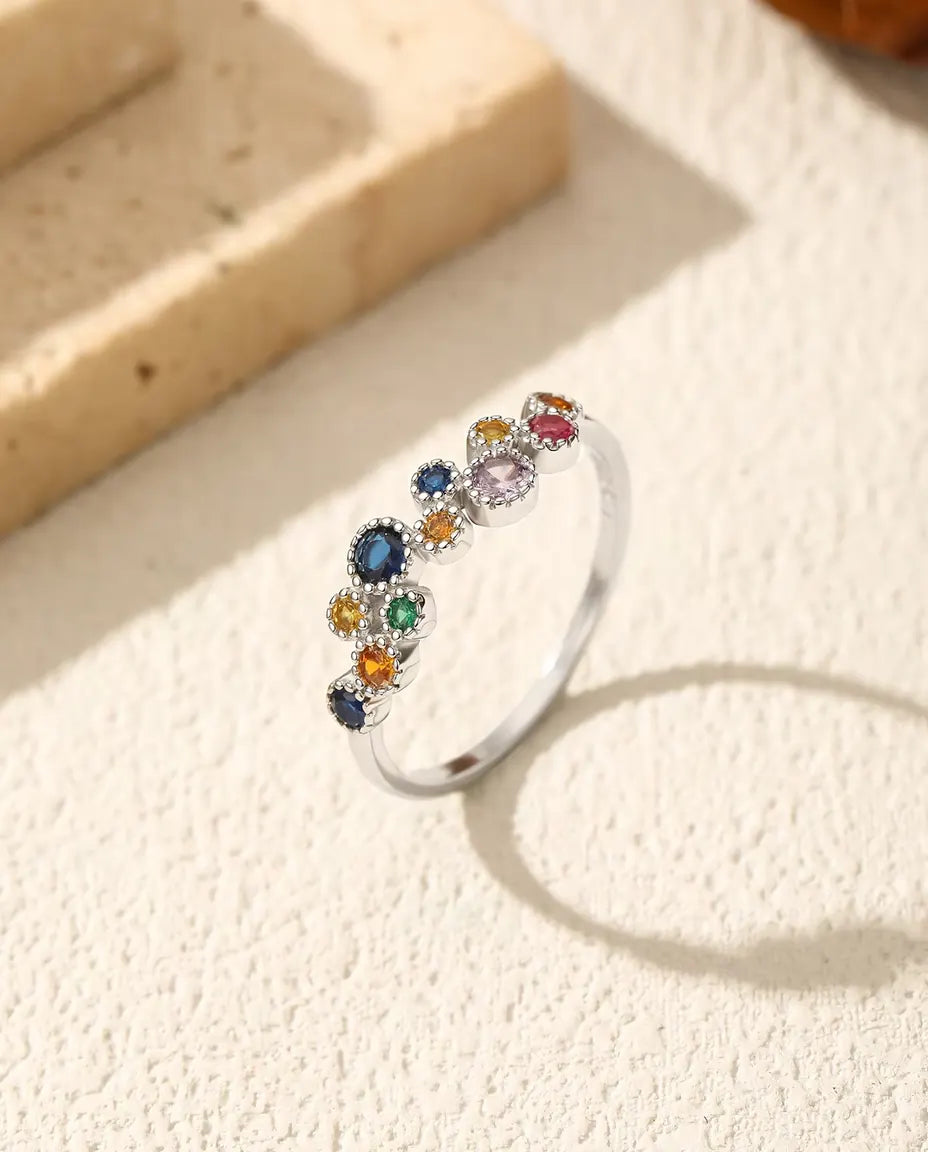 Anello con zirconi multicolore - pietre blu, gialle, verdi e rosa con bordo millegrana, argento 925, misure US 5-9