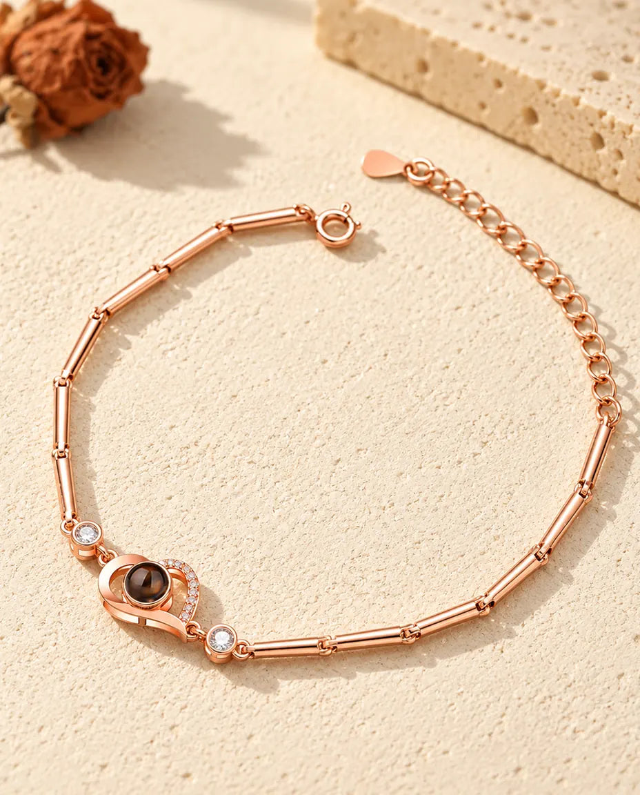 Bracciale color oro rosa con cuore aperto e foto dentro, catena a barrette e prolunga