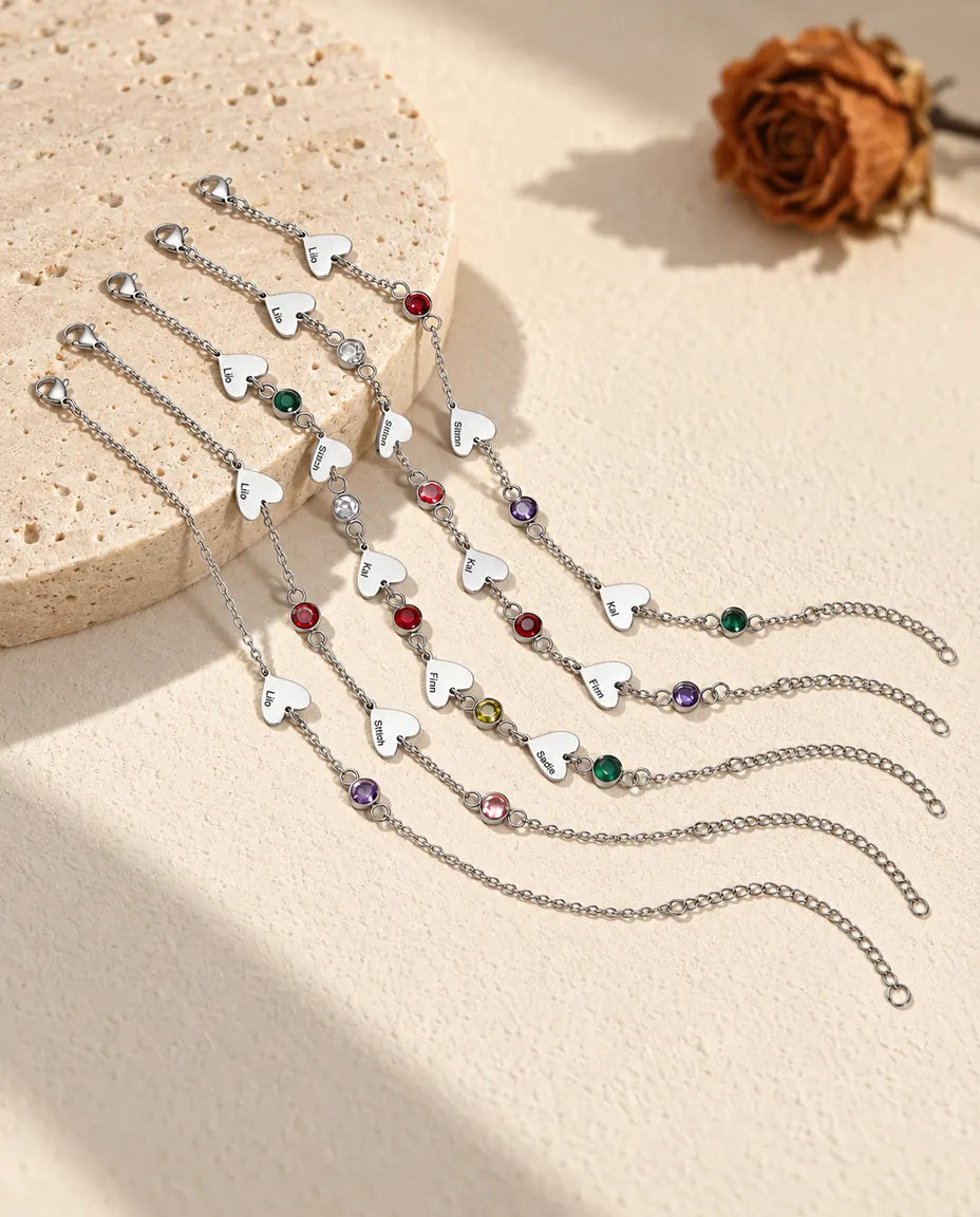 Sei bracciali con nomi affiancati, ciascuno con un numero diverso di cuori e pietre di nascita