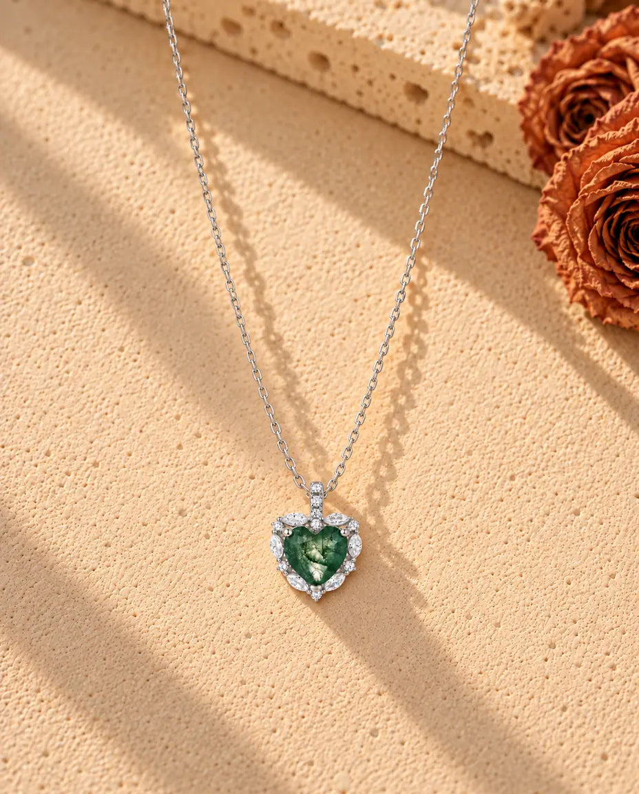 Collana Agata Muschiata Cuore Halo in Argento 925 - la collana intera distesa a lunga V su una superficie chiara ruvida