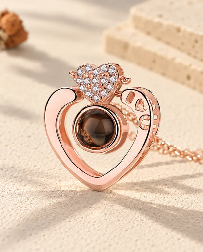 Primo piano del cuore aperto color oro rosa con le lettere I, cuore, U traforate e il cuoricino a pavé