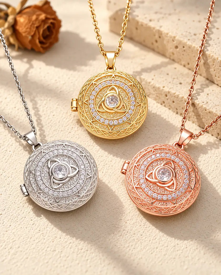 I tre colori della collana portafoto con triquetra celtica disposti su una superficie in gesso